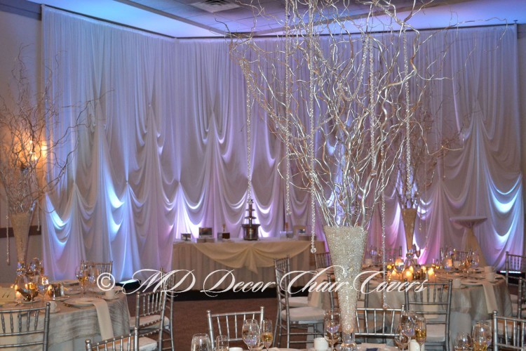Silver chiavari chairs with a multiple light back drop
